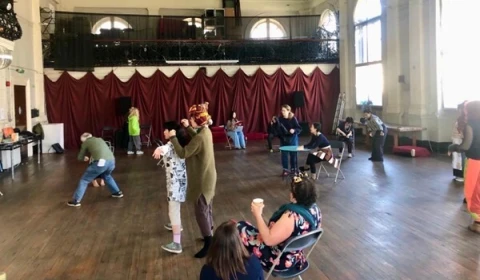 People engaging in different form of performance across an open stage.