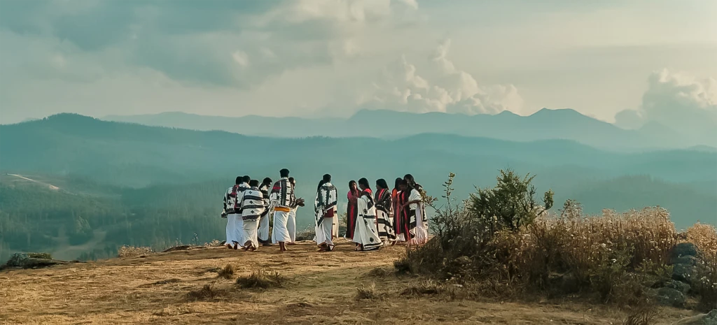 Group of traditionally dressed people on hillside